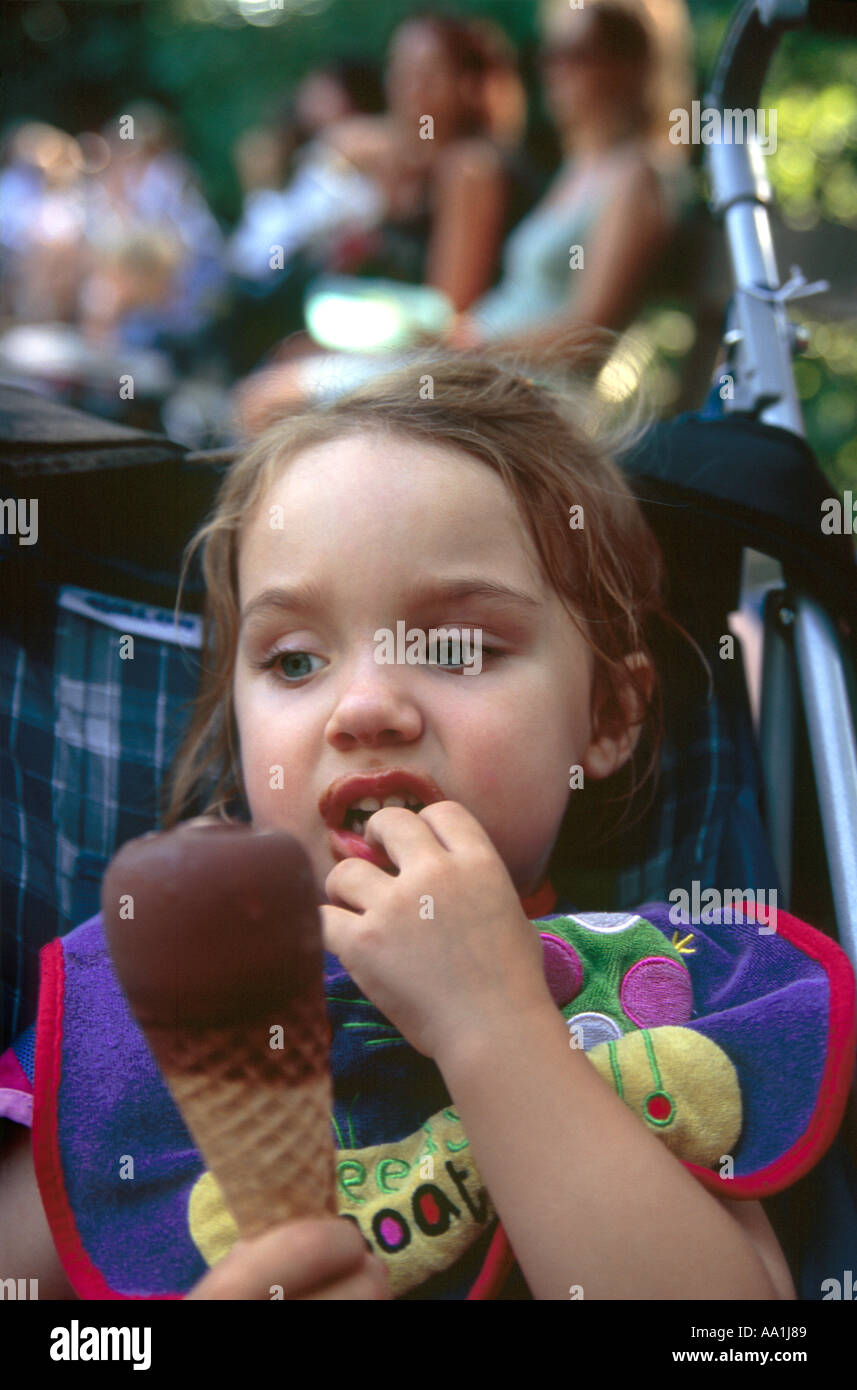 Young girl tempted by chocolate dipped ice cream cone Stock Photo