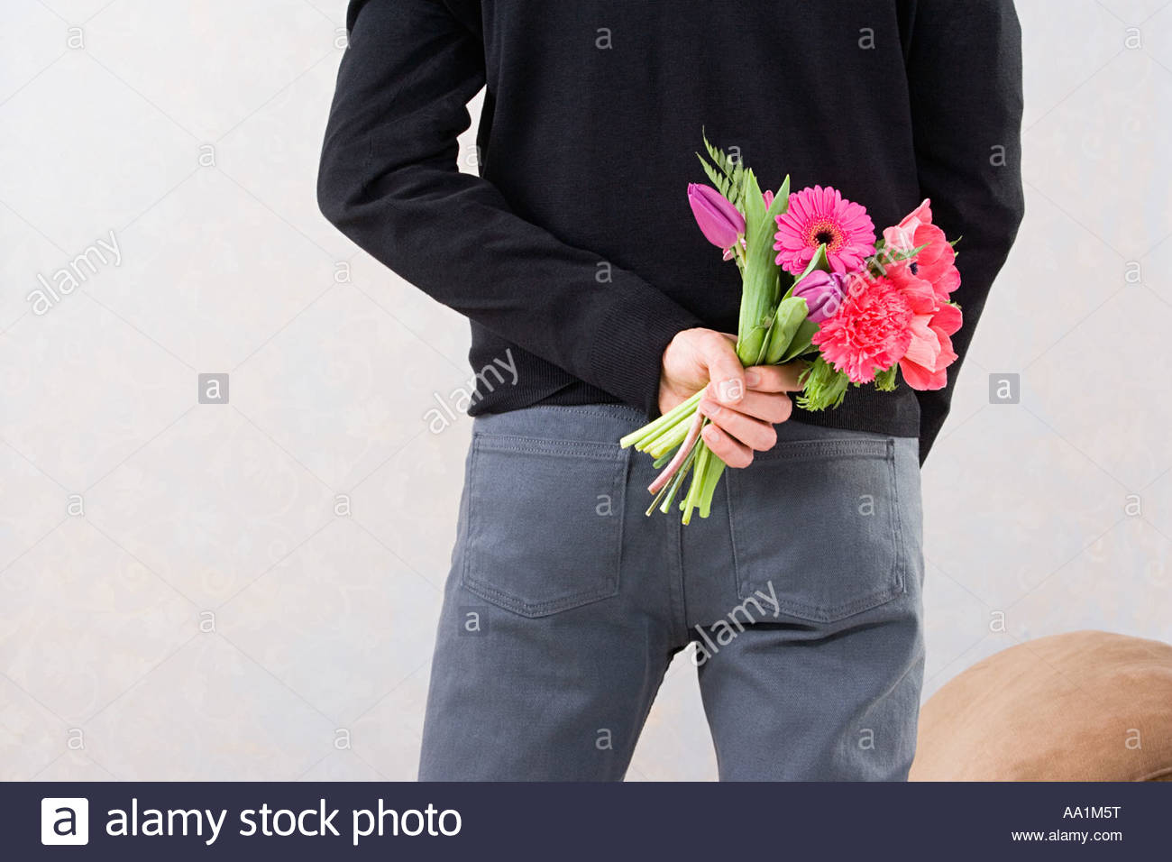 Man Holding Flowers Behind Back