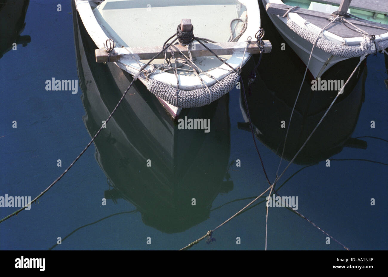 Boats reflections in the water Stock Photo - Alamy
