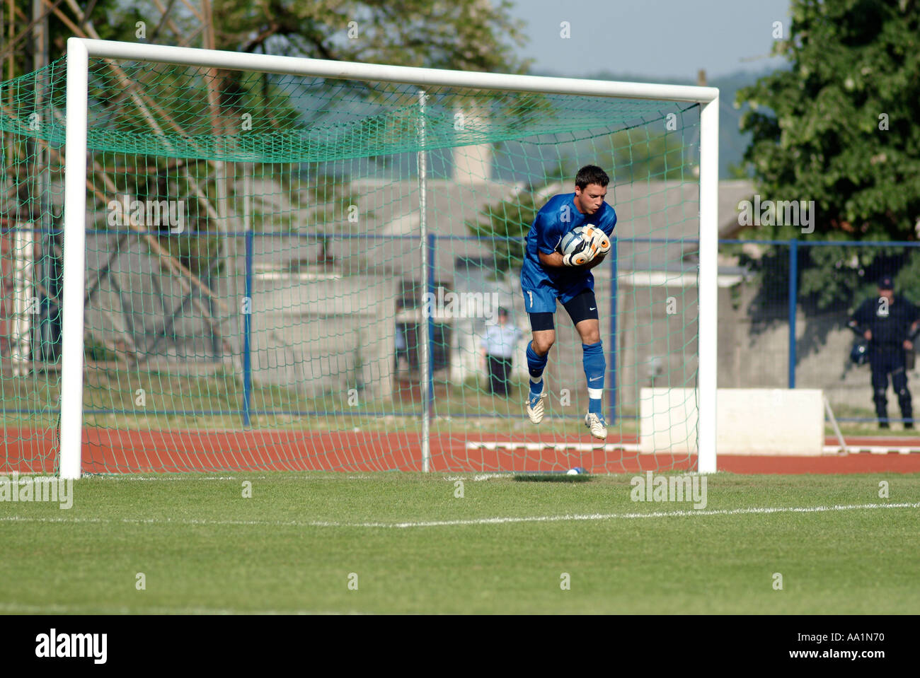 Goalkeeper Makes a Save at a Football Match Stock Photo