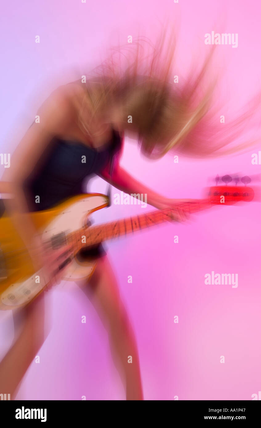 Blurry Caucasian Teen Girl Playing Bass Guitar USA Stock Photo