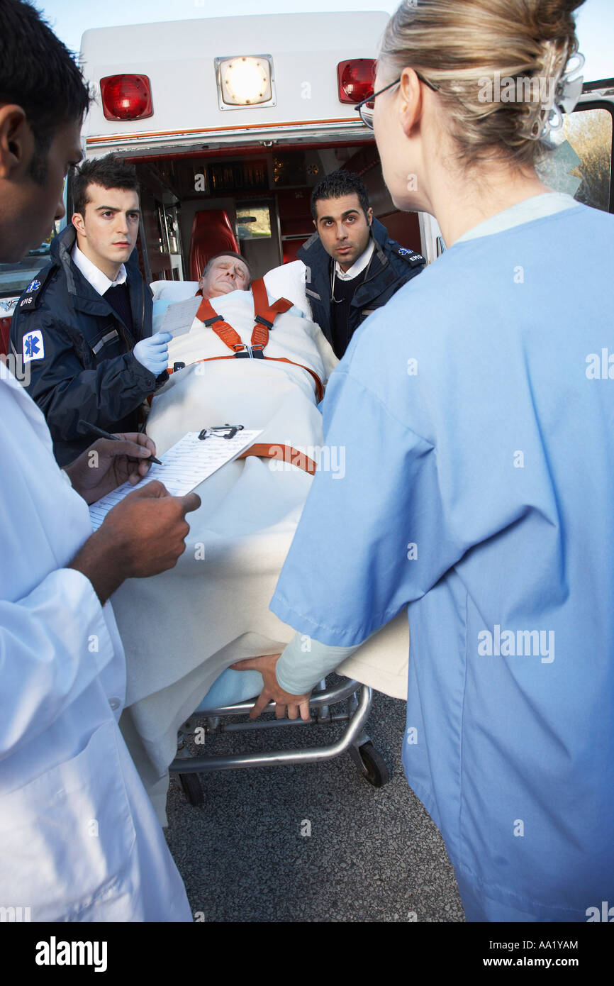 Paramedics and Doctors with Patient on Stretcher Stock Photo