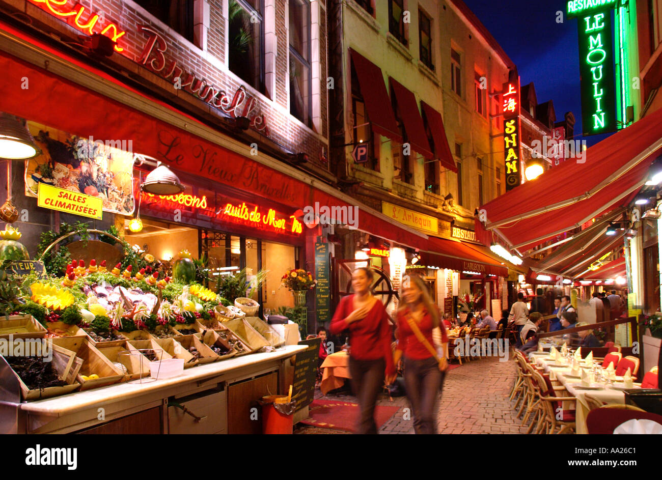 Restaurants at night  on Petite Rue des Bouchers in the historic city centre, Brussels, Belgium Stock Photo