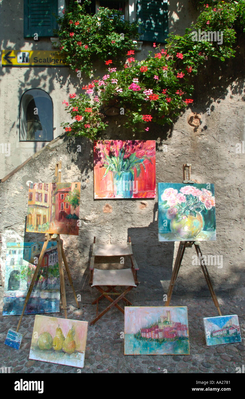 Paintings outside a gallery in Malcesine old town centre, Lake Garda, Italy Stock Photo