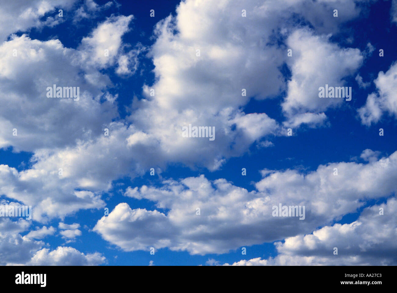 Fluffy white clouds in a blue summer sky Stock Photo - Alamy