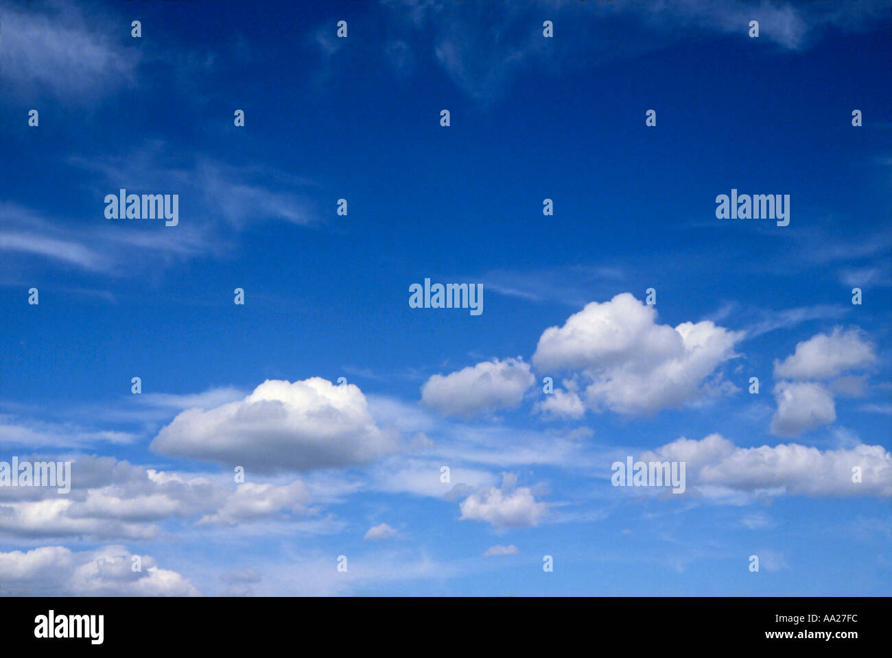 Fluffy white clouds in a blue summer sky Stock Photo - Alamy