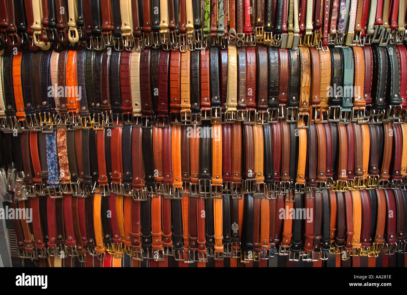 Belts for sale on a leather stall in a city centre market, Florence, Tuscany, Italy Stock Photo