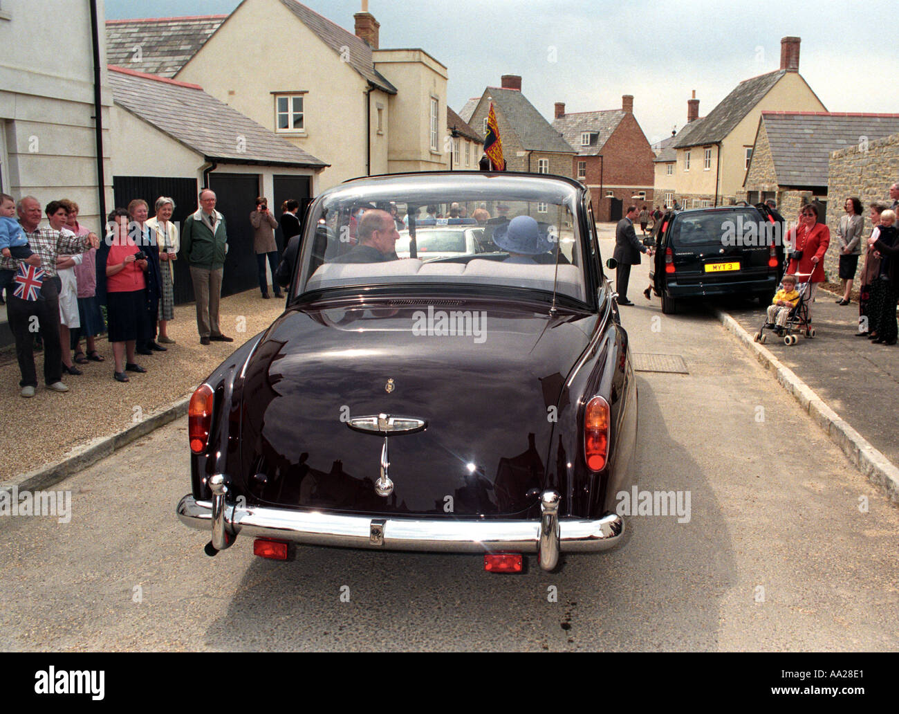 Queen Elizabeth II and Prince Phillip leave after a visit to her son s Poundbury Village project Stock Photo
