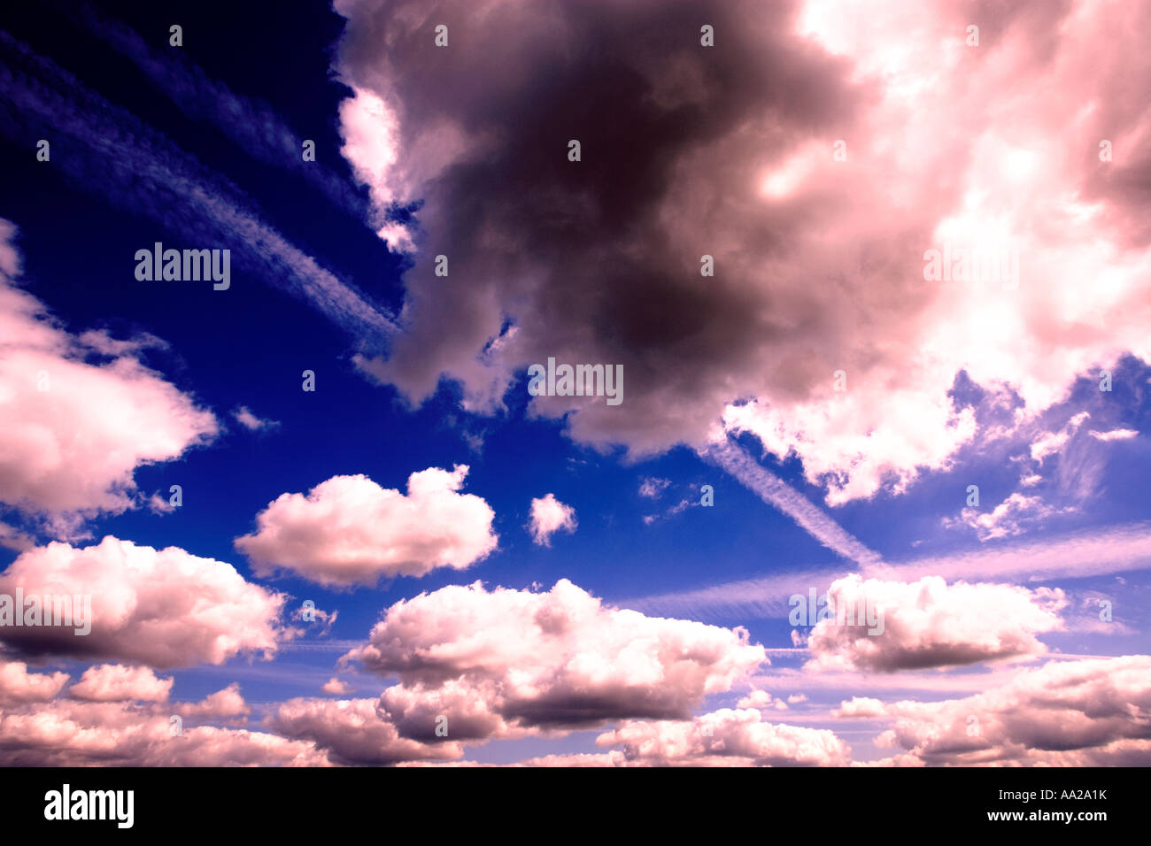 Blue sky with fluffy white clouds Stock Photo - Alamy