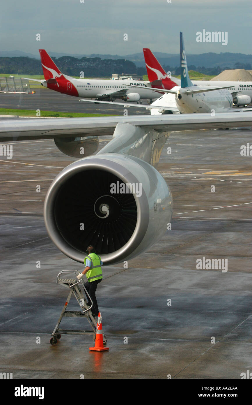 An flight engineer inspects the engine of a Boeing 747 Jet aircraft at Auckland International Airport Stock Photo