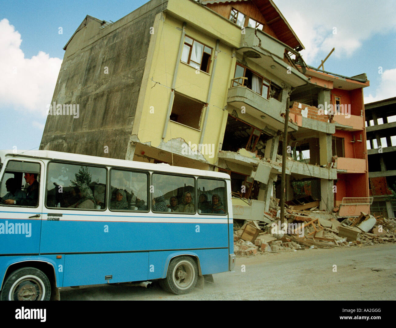 Bus passing the remains of a building destroyed during the 1999