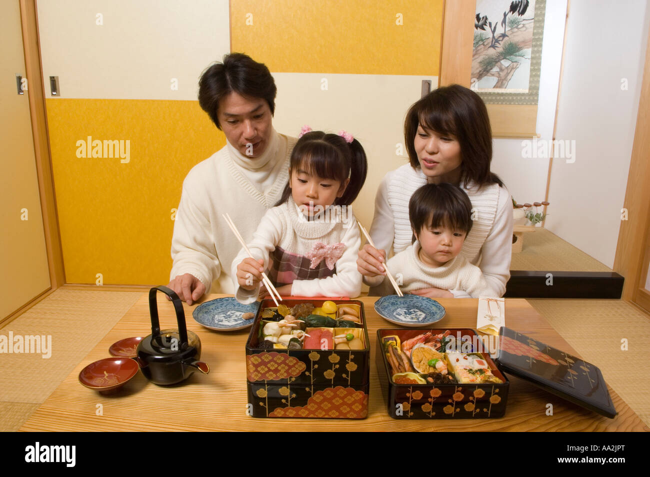 Family eating New Year s Day meal Stock Photo Alamy