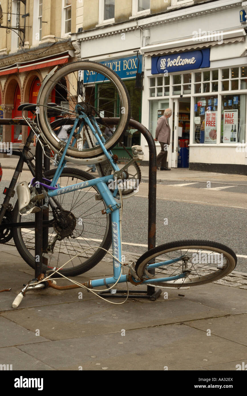 Bicycle parked in city urban bike parking rack but tipped up and ...