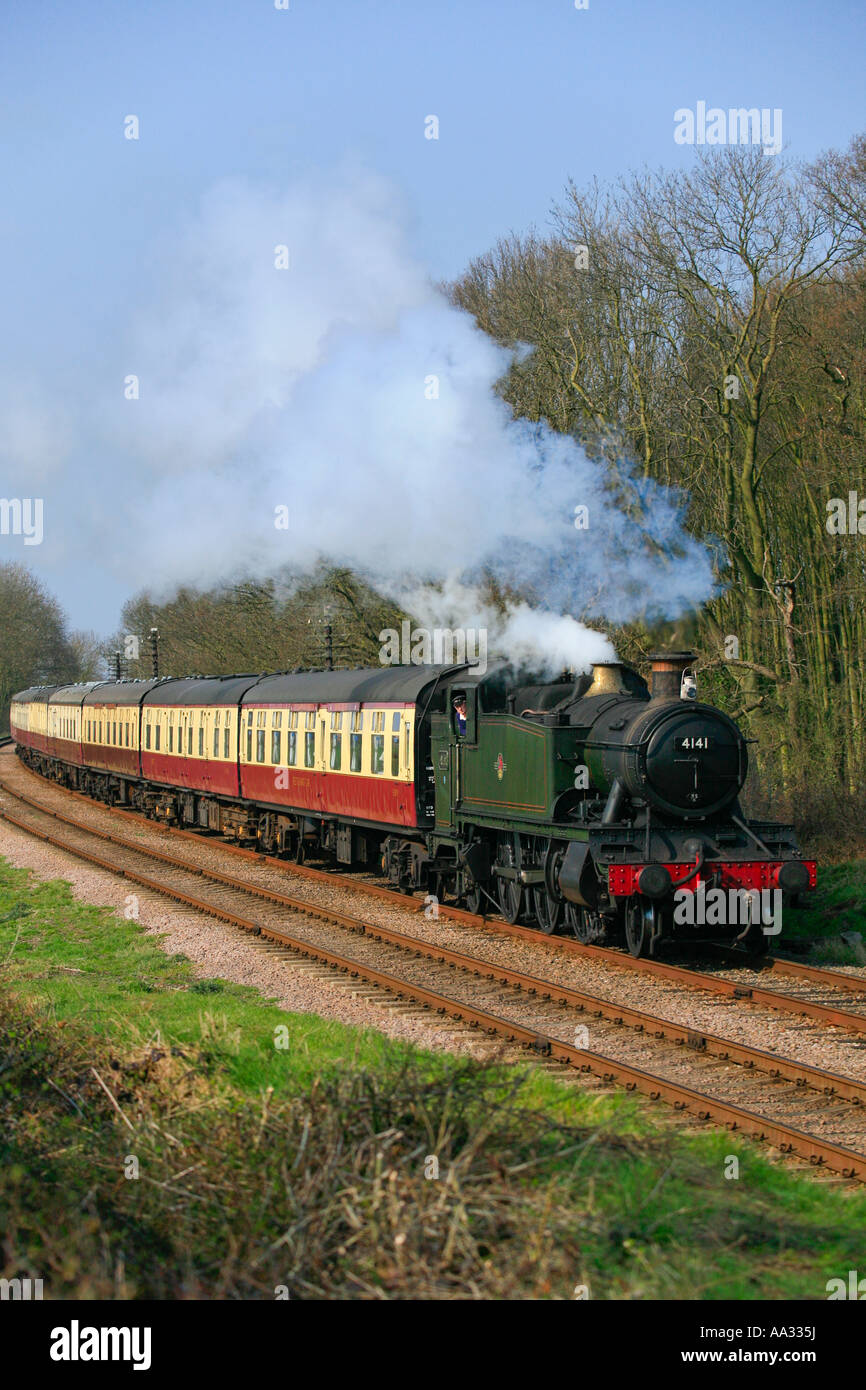 Steam train pulling passenger coaches hires stock photography and