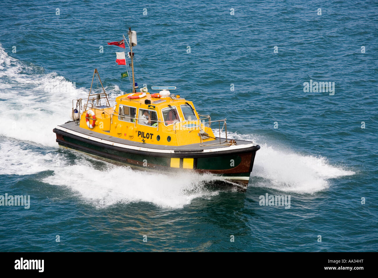 The Poole pilot launch Venture arriving to deliver the pilot to an incoming Channel Islands ferry Stock Photo