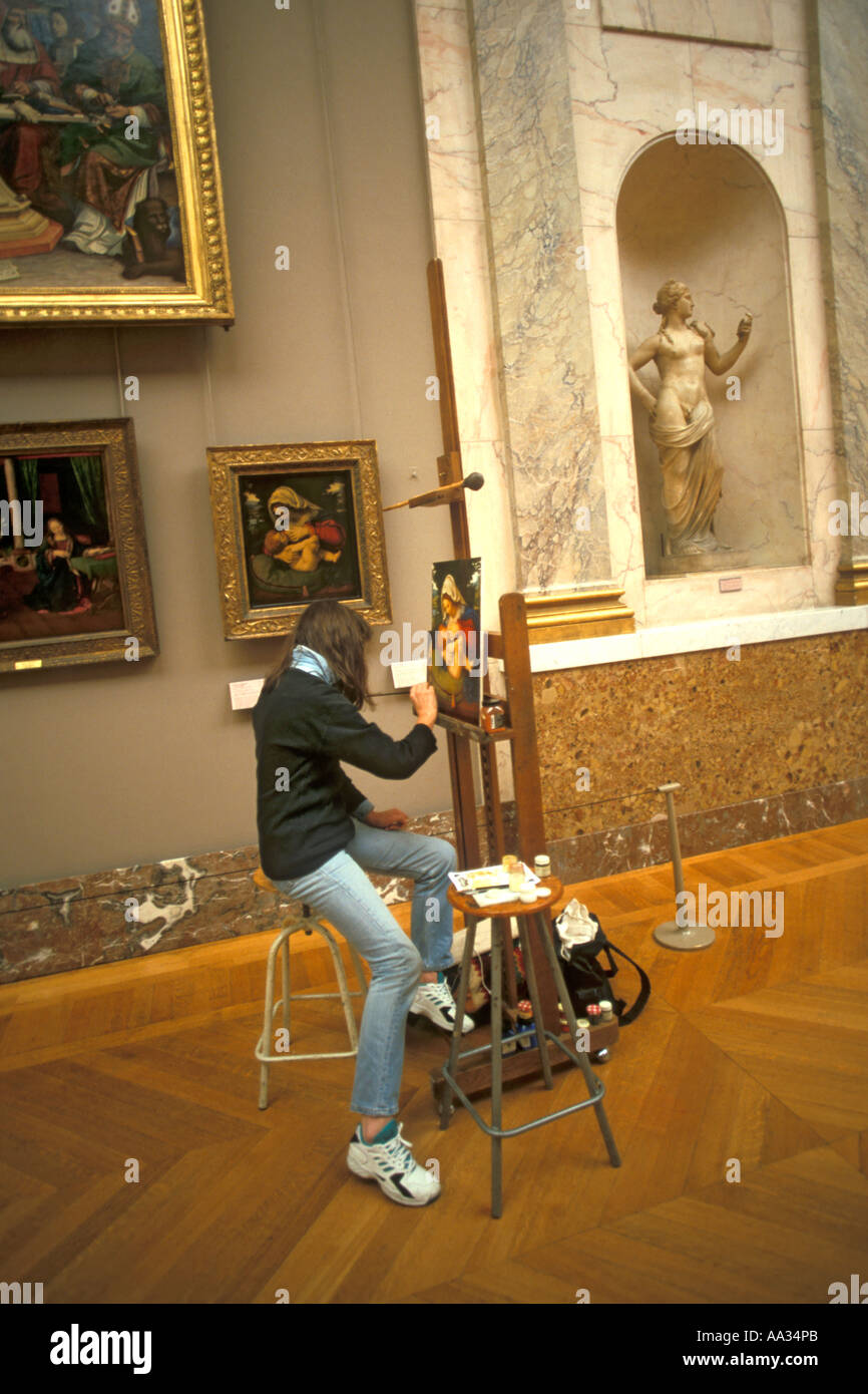 France Paris the Louvre museum a young woman artist copies a painting