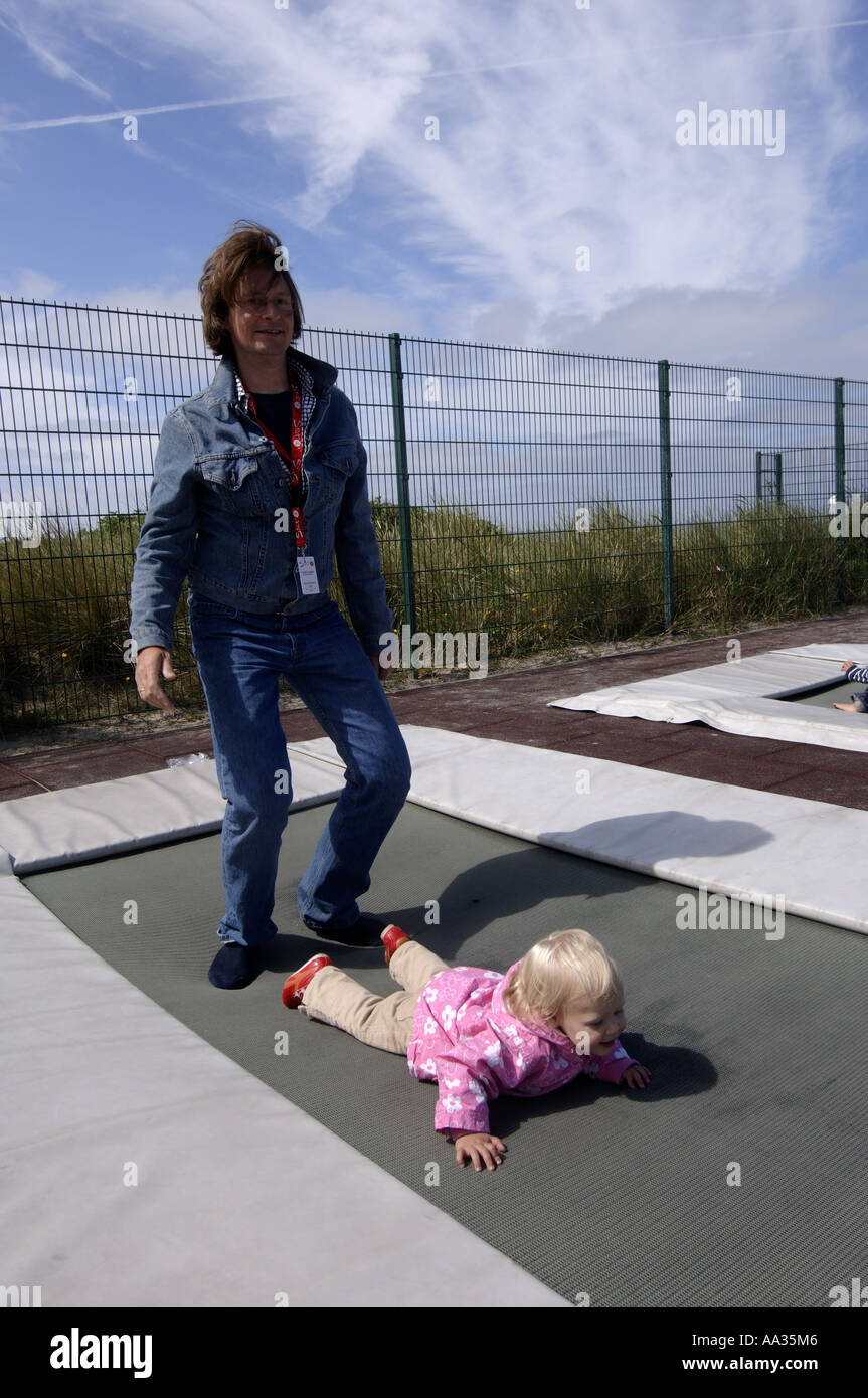 Sylt father and daughter having fun on a trampoline Stock Photo