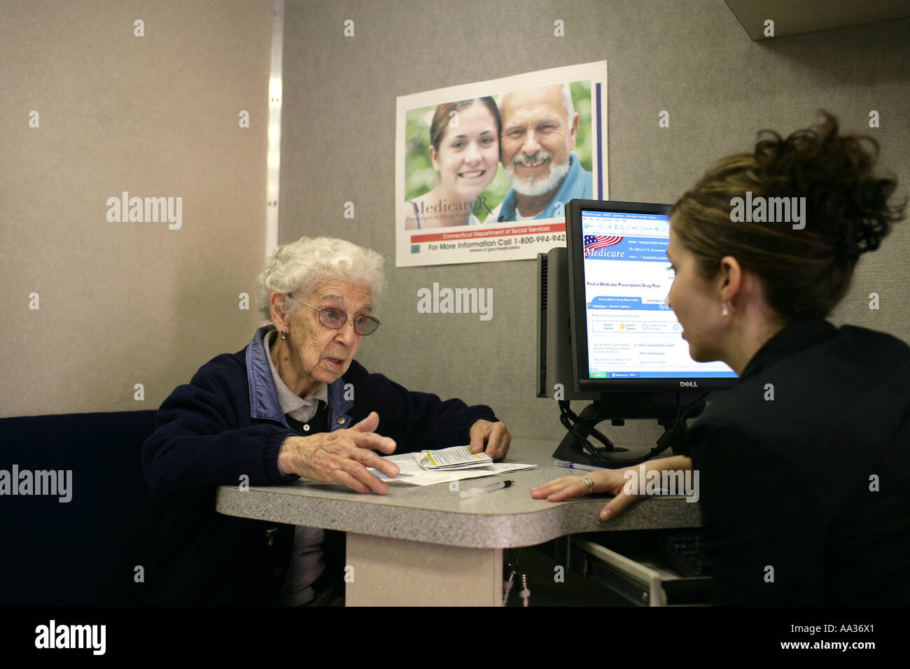 Elderly woman getting new US Prescription drug plan explained to her by expert as seniors had to chose which plan to use Stock Photo