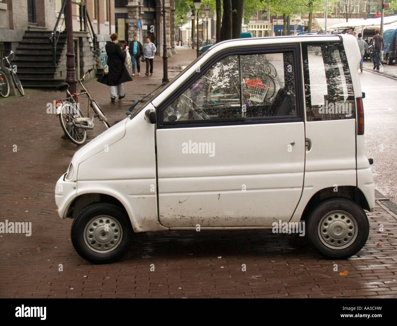 Personal city vehicle the tiny white Canta LX Amsterdam The Netherlands Stock Photo