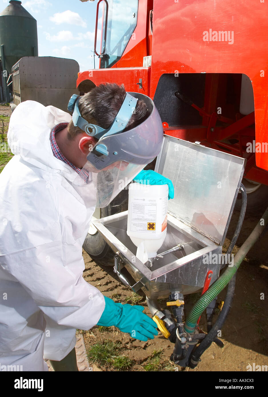 An agricultural contractor filling up his sprayer with chemicals to