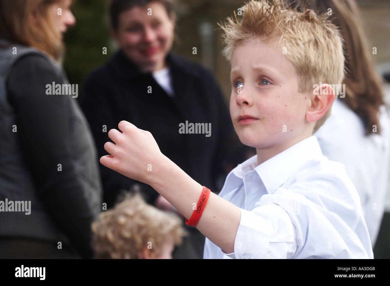 Small child lost in a crowd Stock Photo
