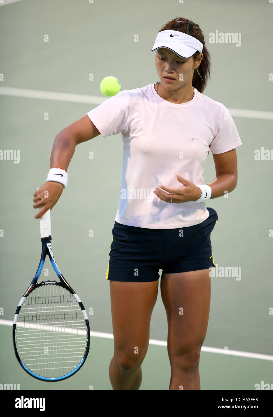 Chinese tennis star Li Na in action in Doha Qatar March 2006 against Daniella Hantuchova Stock Photo