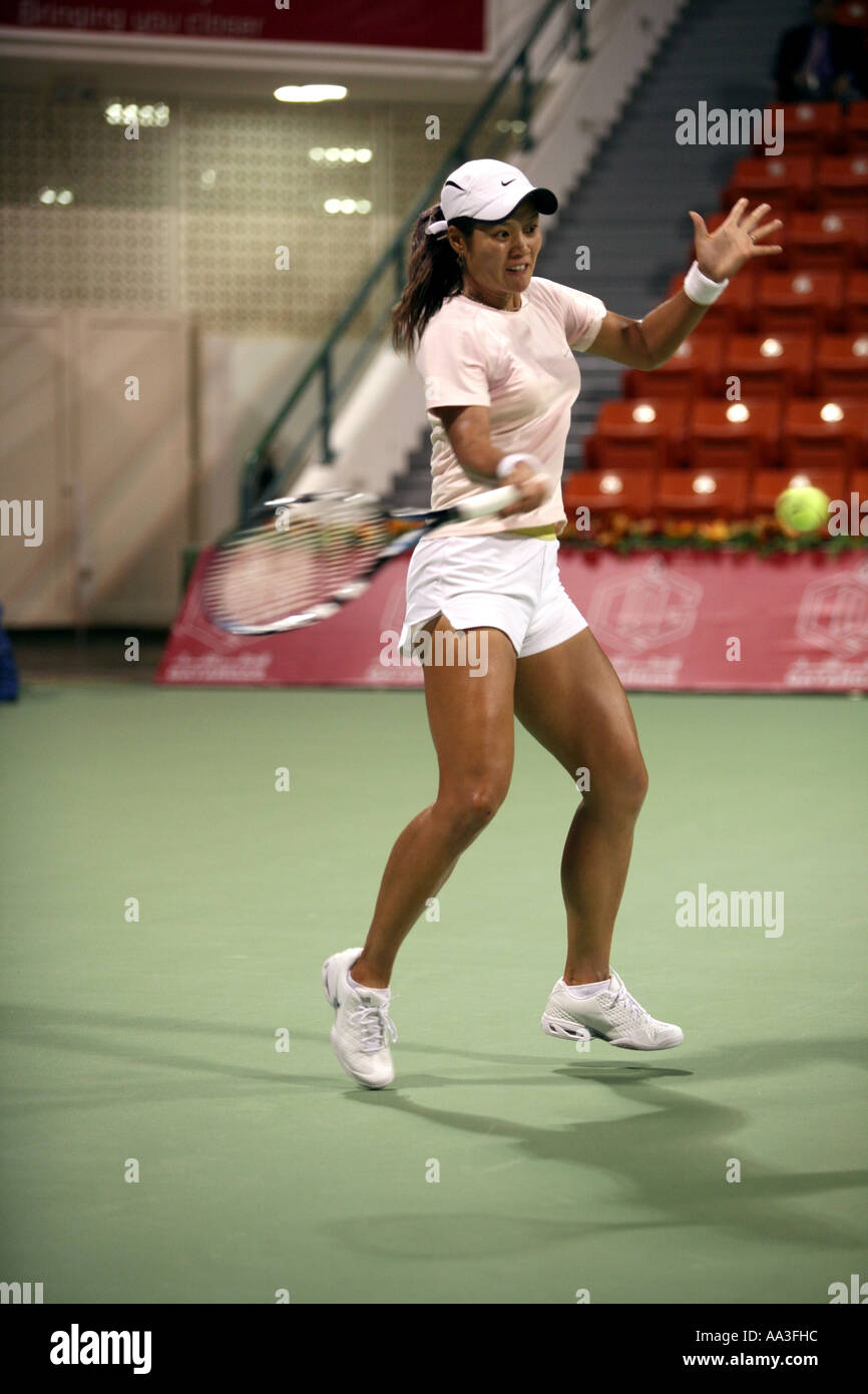 Chinese tennis star Li Na in action in Doha Qatar March 2006 against Nadia Petrova Stock Photo