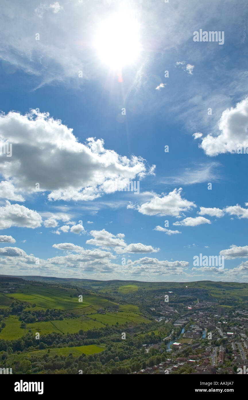 Sun blue sky and clouds over the town of Sowerby Bridge West Yorkshire UK Stock Photo