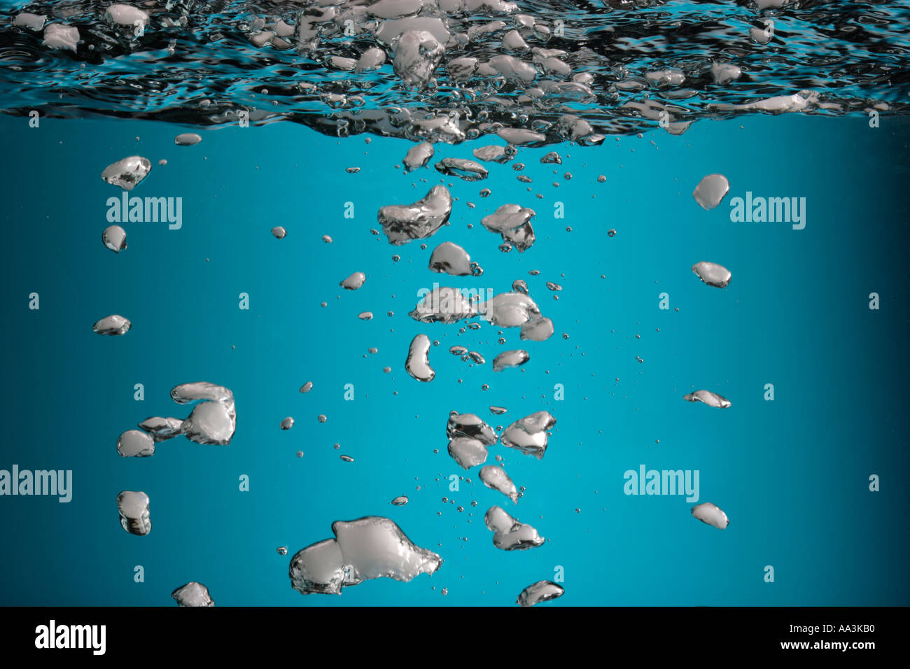 water and air bubbles and water surface from below Stock Photo
