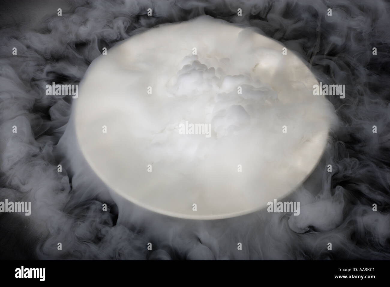 Dry ice CO2 gas spilling out of a bowl Stock Photo