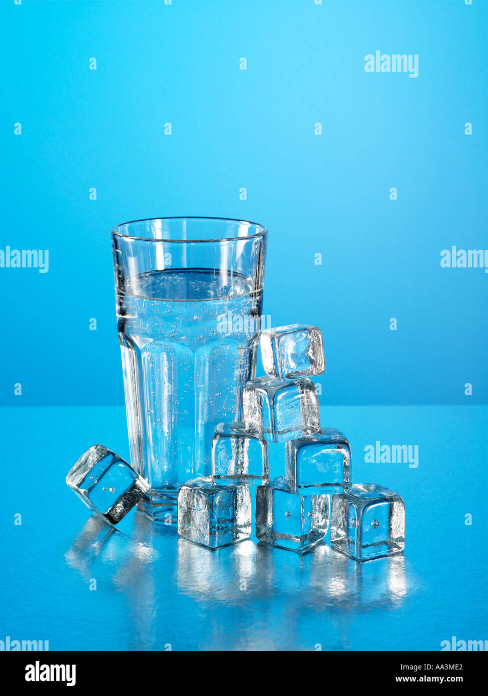 Glass of fizzy water with ice cubes Stock Photo - Alamy