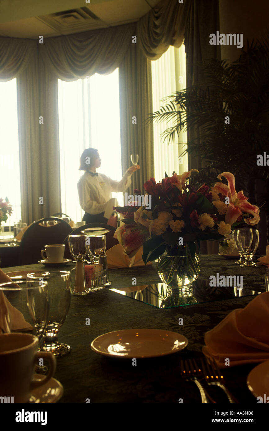 A Waitress Polishes A Water Glass Before A Wedding Reception At A