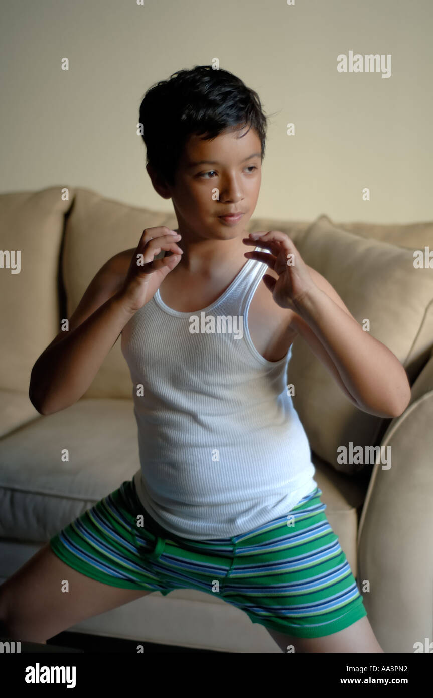 Young boy in underwear playing and making funny facial expressions