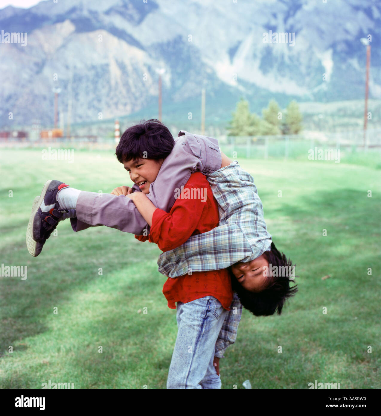 Canadian First Nation Interior Salish boys happy children playing outside in a park Lillooet British Columbia Canada  KATHY DEWITT Stock Photo