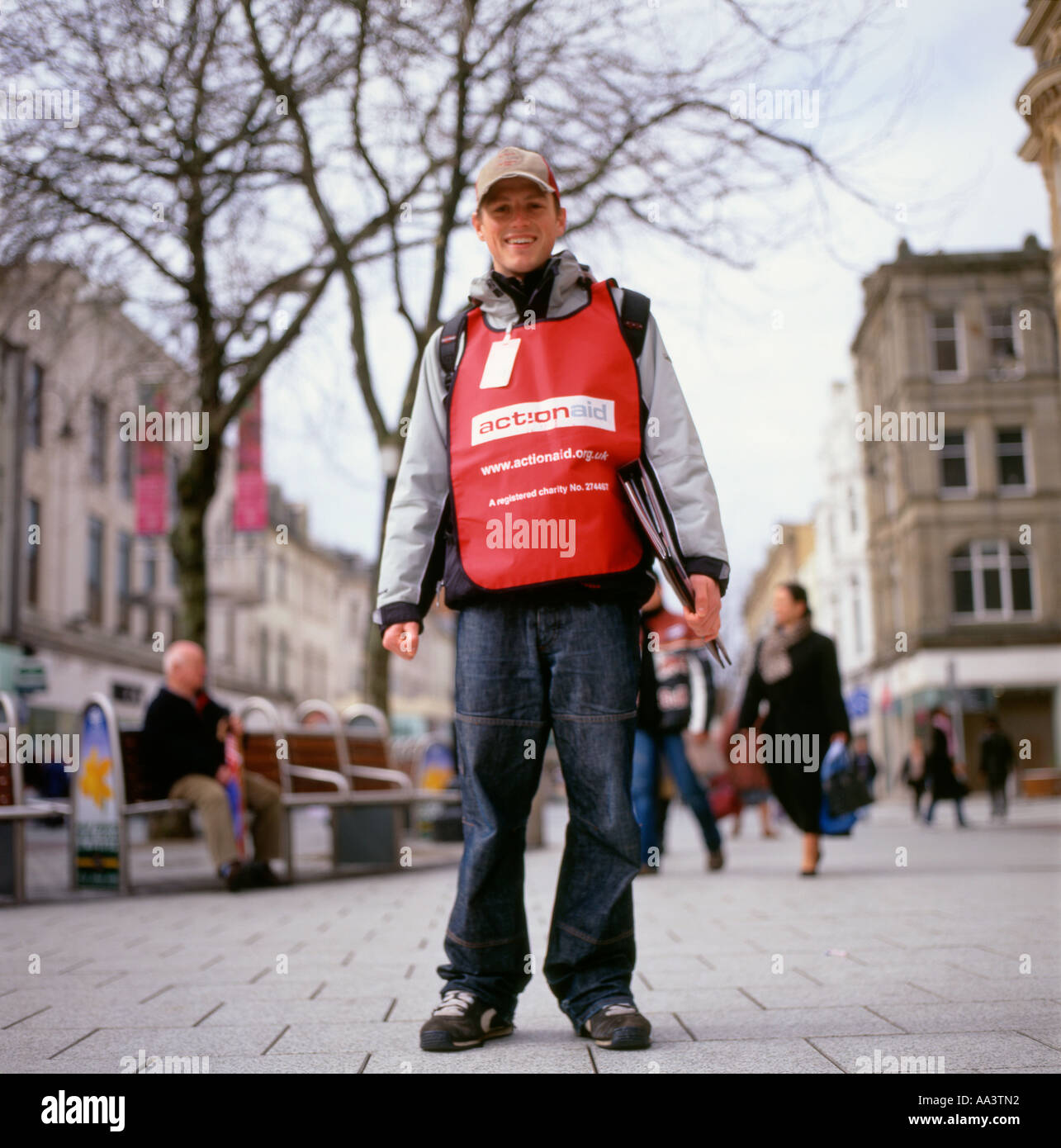Charity Worker Smiling Young Man Chugger Canvassing On Queen Street In charity-worker-smiling-young-man-chugger-canvassing-on-queen-street-in