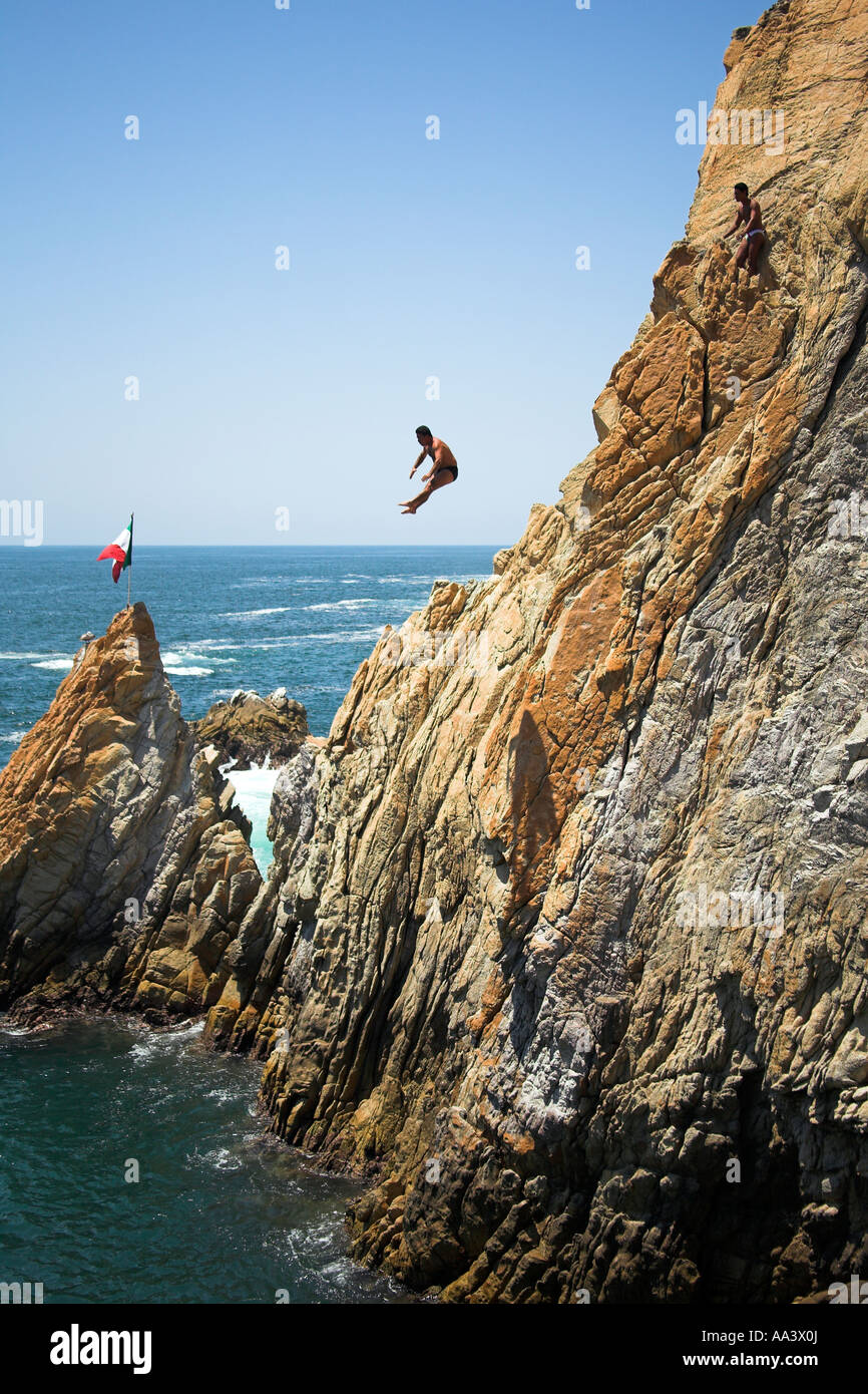 Cliff diver, a clavadista, diving off the cliffs at La Quebrada