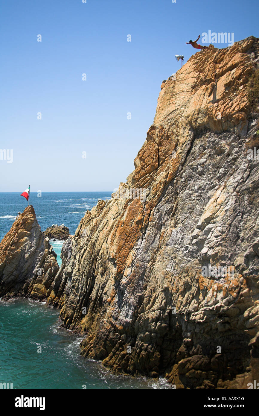 Cliff diver, a clavadista, diving off the cliffs at La Quebrada
