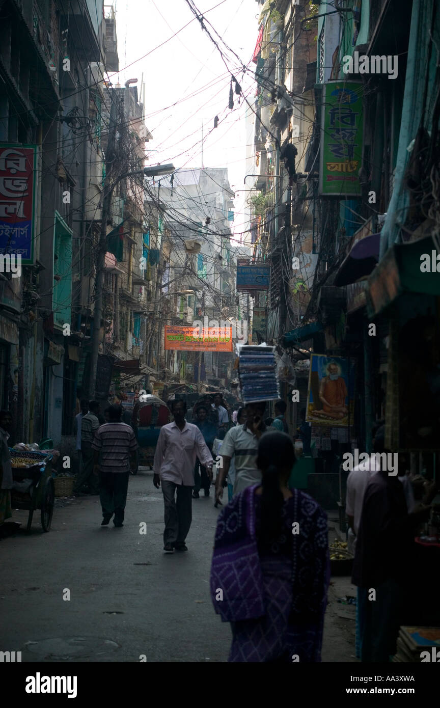 A spaghetti junction of tangled telephone and power cables clutter the alleyways of Old Town Dhaka, Bangladesh Stock Photo