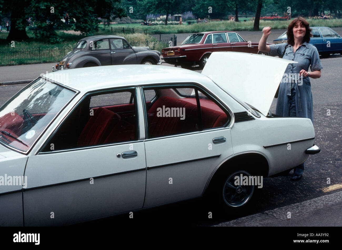 White Vauxhall Cavalier car from 1977 with a young woman opening the boot trunk Stock Photo