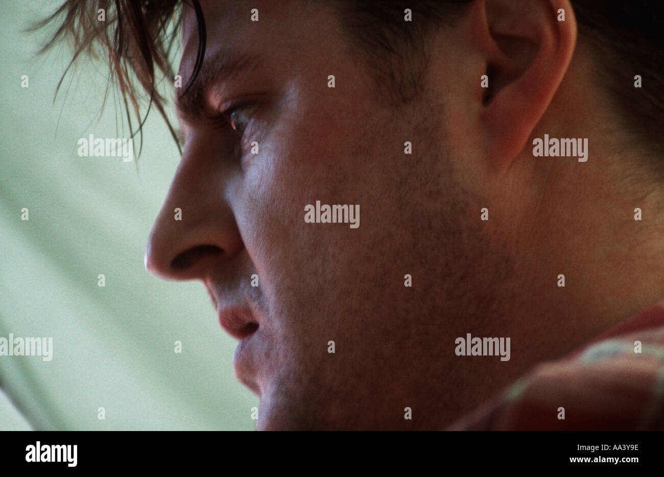 Close up profile of a young man with a concerned expression Stock Photo