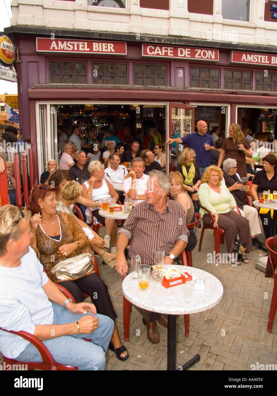 Crowds at cafe bar in Nieuwmarkt square watch outdoor entertainment Amsterdam The Netherlands Stock Photo