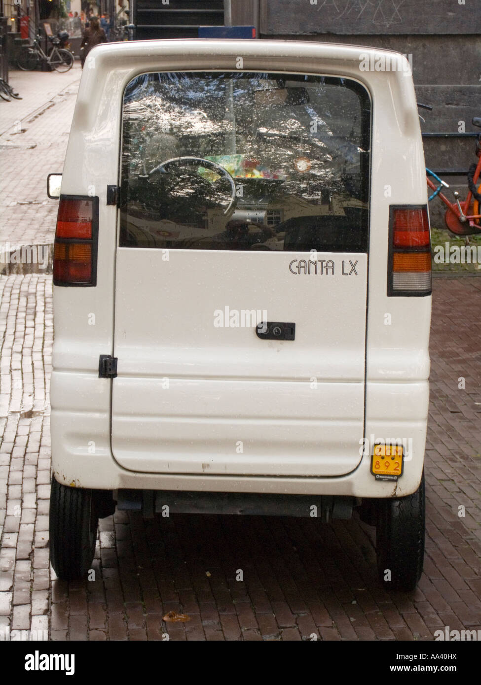 Personal city vehicle the tiny white Canta LX Amsterdam The Netherlands Stock Photo