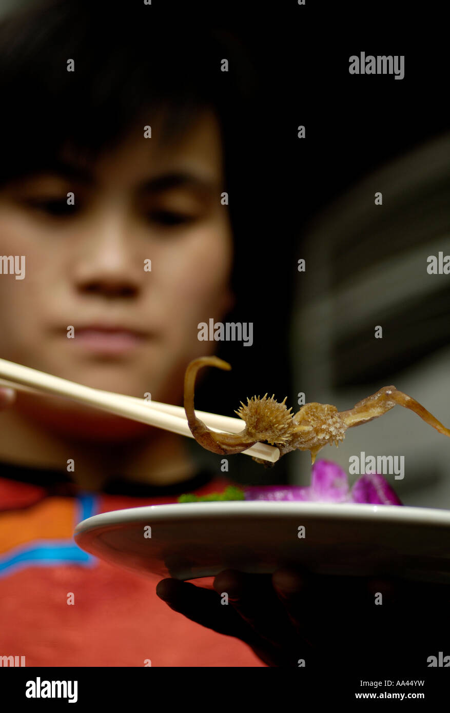 A waitress shows a snake penis to be cooked at a restaurant called  Guolizhuang in West Lake of Beijing China March 10 2006 Stock Photo - Alamy