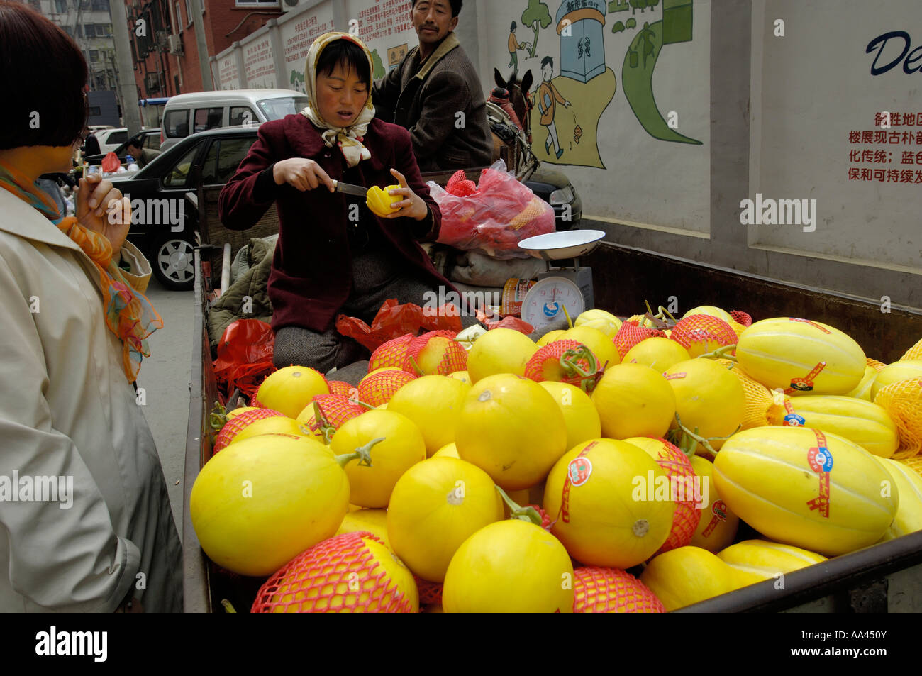 Chinese farmer vendors sell local fruits on a street of Beijing China Apri 21 2006 Stock Photo