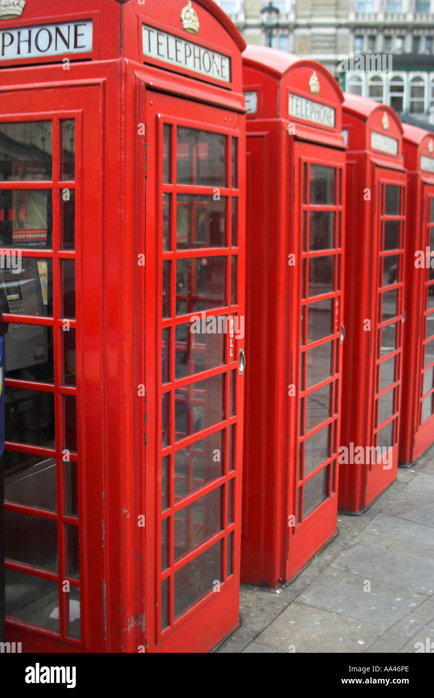 A portrait format image of a line of red iconic phone boxes in London, England. Stock Photo