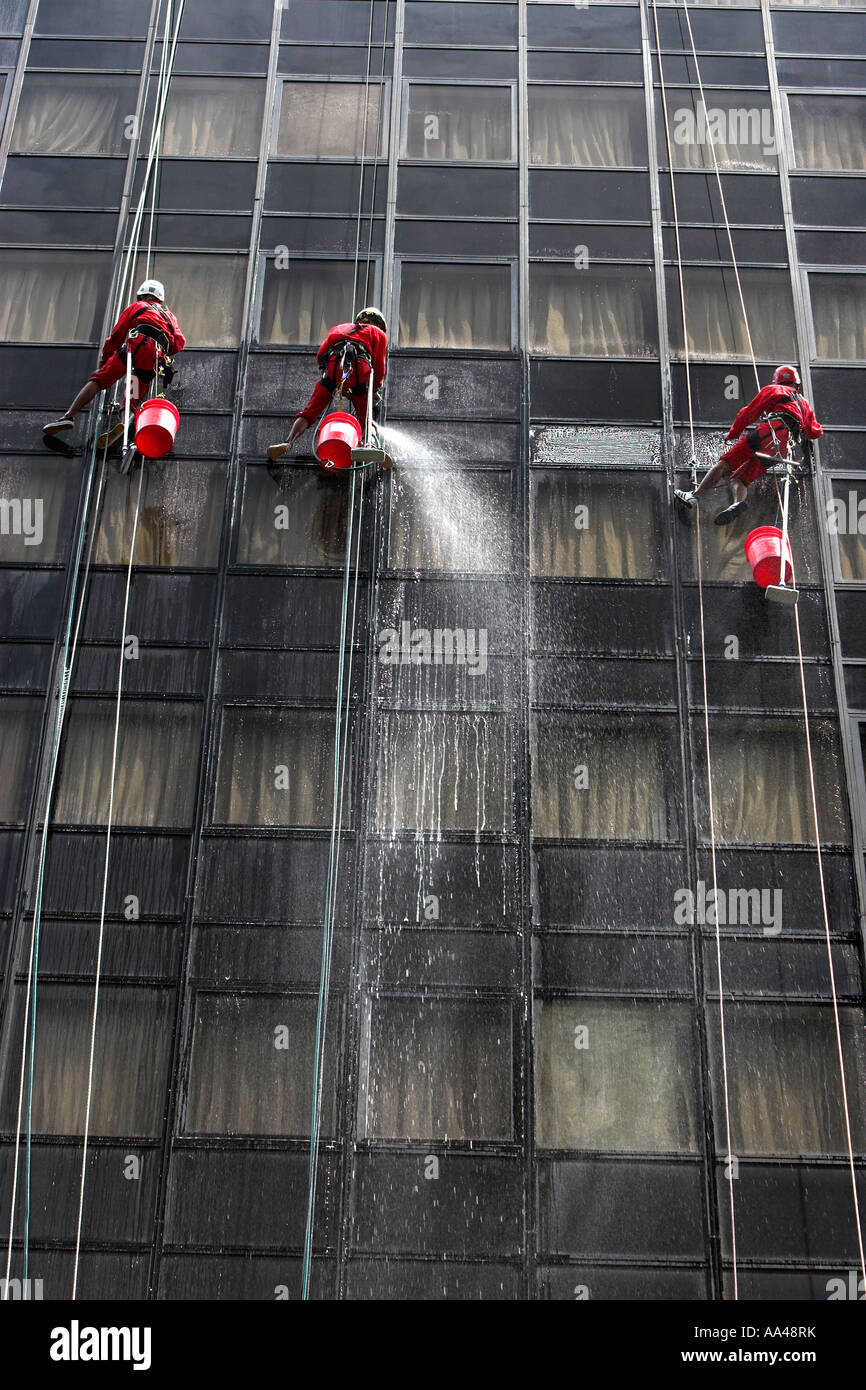 High rise window cleaners work suspended on ropes Orchard Road