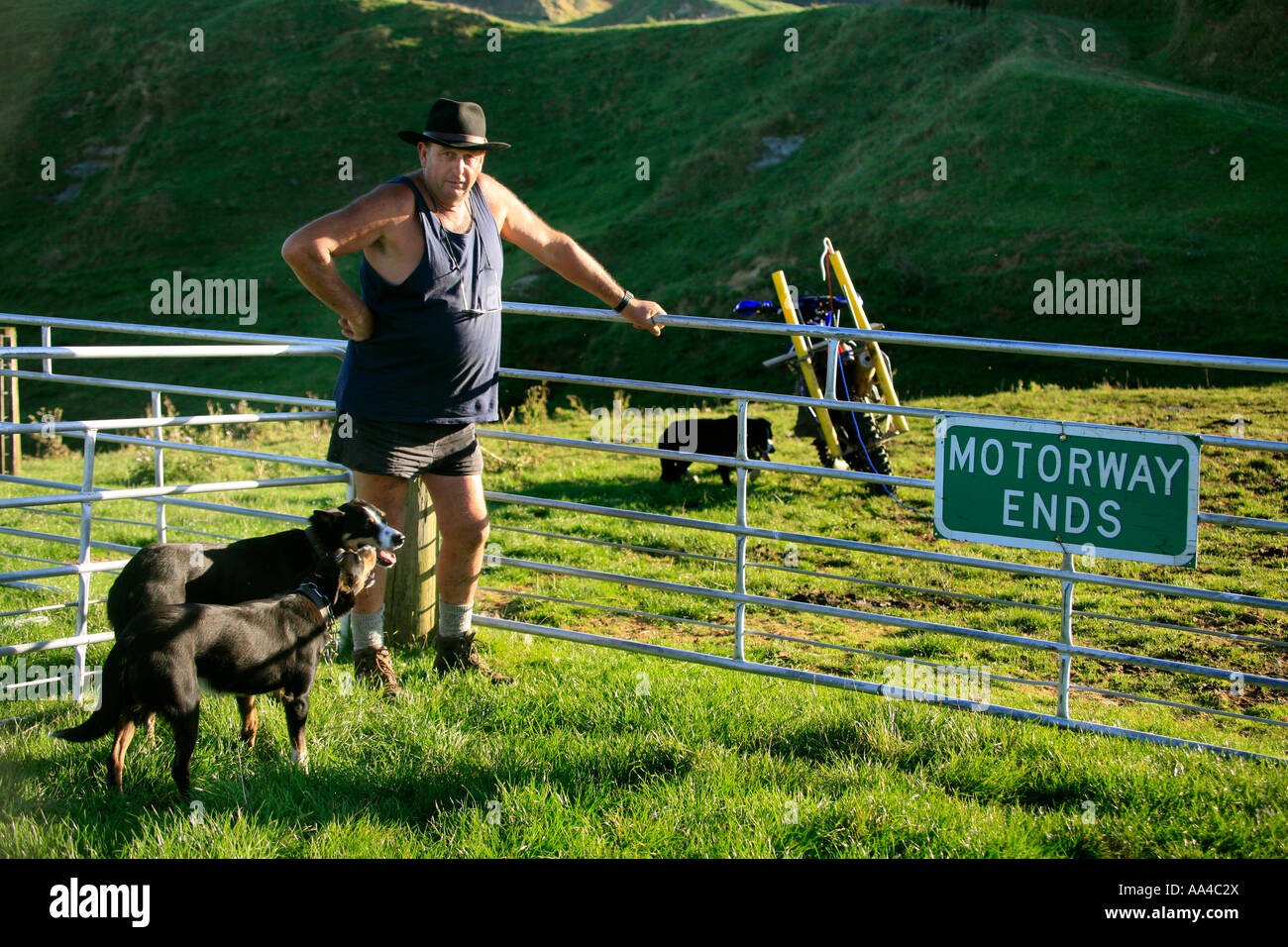 Taranaki farmer Bryan Hocken with a comical sign out the back of his back country farm Stock Photo