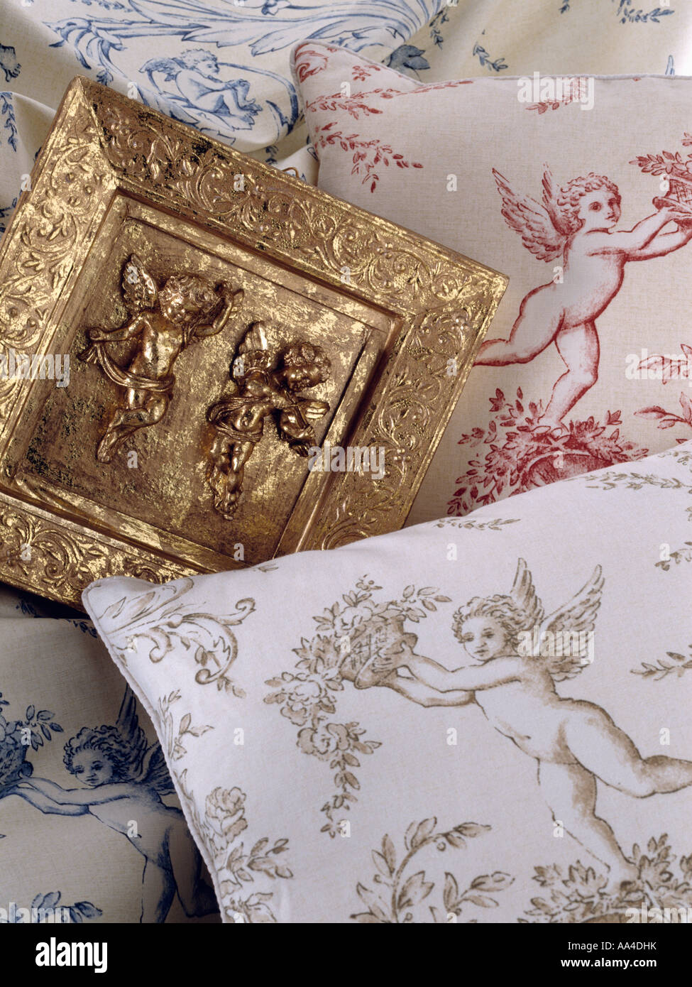 Small gold plaque with angel motif and fabric with cherub pattern Stock ...