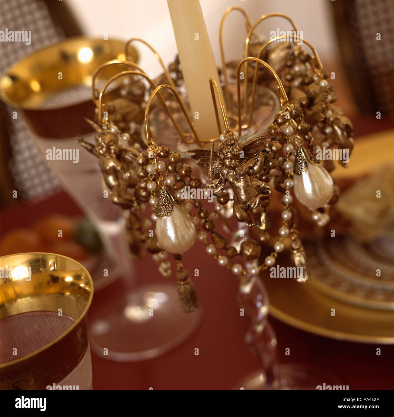 Close Up Of Gold Bead Chain And Pearls Decorating Candlestick
