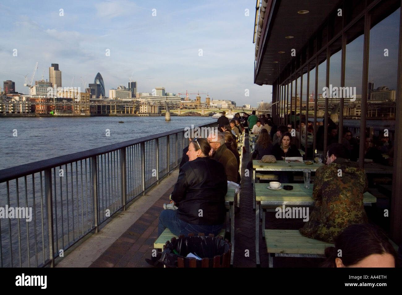 People enjoying a sunny spring day out on a river pub London UK Stock Photo